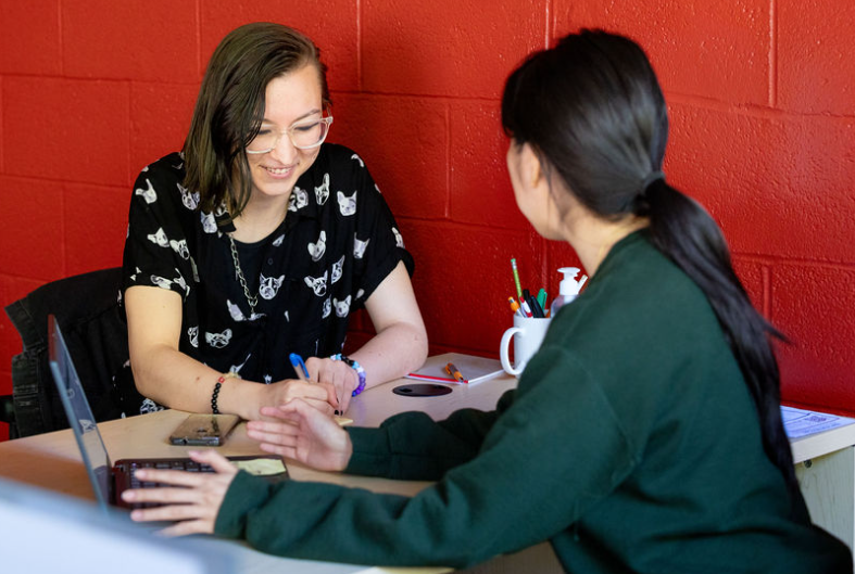 CCAS Peer advisor smiling at an office desk